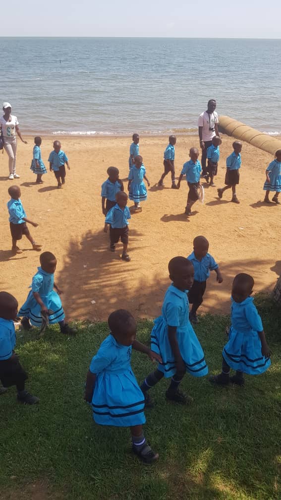 Children on a school outing to the lake shore